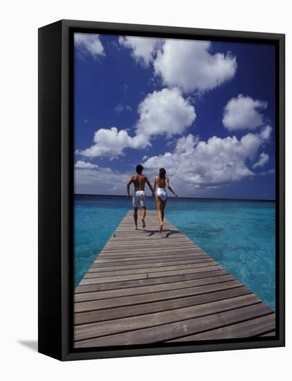 Couple Running on Dock, Curacao, Caribbean-Greg Johnston-Framed Premier Image Canvas