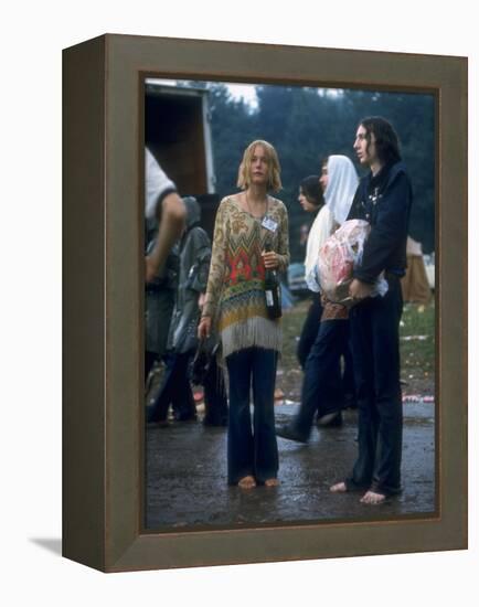 Couple Standing Barefoot on a Road Holding a Bundle and Wine Bottle, Woodstock Music and Art Fair-John Dominis-Framed Premier Image Canvas