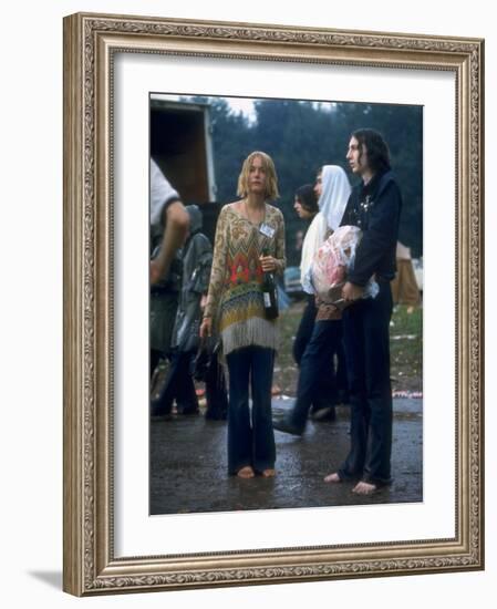 Couple Standing Barefoot on a Road Holding a Bundle and Wine Bottle, Woodstock Music and Art Fair-John Dominis-Framed Photographic Print