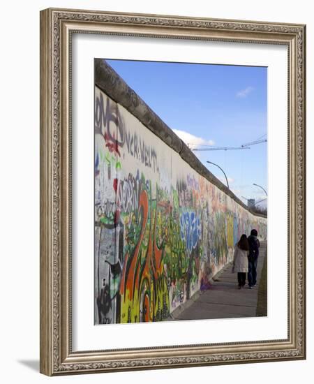 Couple Walking Along the East Side Gallery Berlin Wall Mural, Berlin, Germany, Europe-Simon Montgomery-Framed Photographic Print