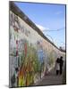 Couple Walking Along the East Side Gallery Berlin Wall Mural, Berlin, Germany, Europe-Simon Montgomery-Mounted Photographic Print