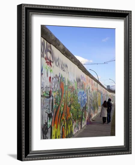 Couple Walking Along the East Side Gallery Berlin Wall Mural, Berlin, Germany, Europe-Simon Montgomery-Framed Photographic Print