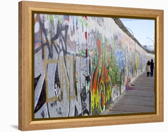 Couple Walking Along the East Side Gallery Berlin Wall Mural, Berlin, Germany, Europe-Simon Montgomery-Framed Premier Image Canvas