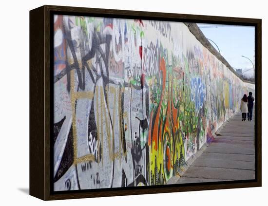 Couple Walking Along the East Side Gallery Berlin Wall Mural, Berlin, Germany, Europe-Simon Montgomery-Framed Premier Image Canvas