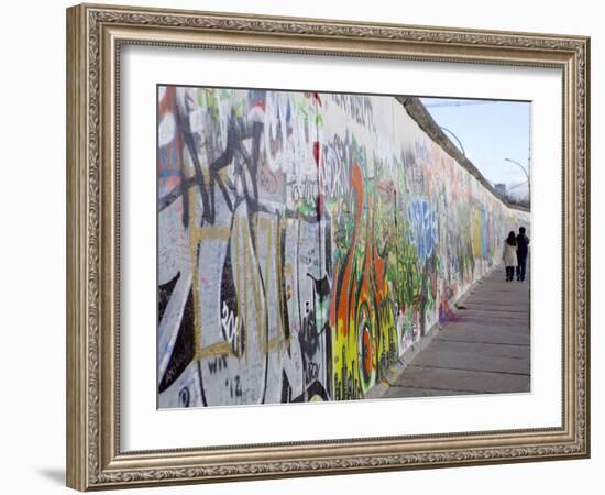 Couple Walking Along the East Side Gallery Berlin Wall Mural, Berlin, Germany, Europe-Simon Montgomery-Framed Photographic Print