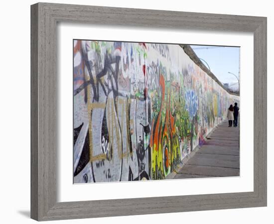 Couple Walking Along the East Side Gallery Berlin Wall Mural, Berlin, Germany, Europe-Simon Montgomery-Framed Photographic Print