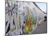 Couple Walking Along the East Side Gallery Berlin Wall Mural, Berlin, Germany, Europe-Simon Montgomery-Mounted Photographic Print