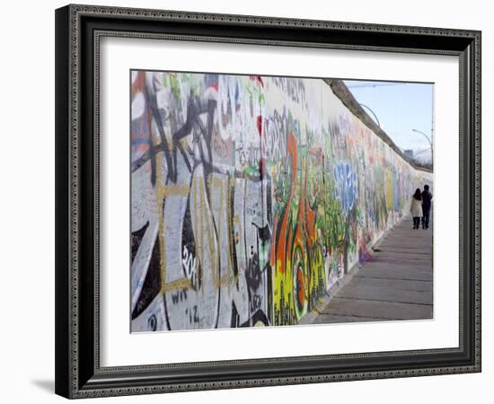 Couple Walking Along the East Side Gallery Berlin Wall Mural, Berlin, Germany, Europe-Simon Montgomery-Framed Photographic Print