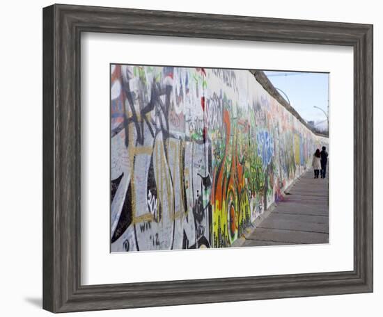 Couple Walking Along the East Side Gallery Berlin Wall Mural, Berlin, Germany, Europe-Simon Montgomery-Framed Photographic Print