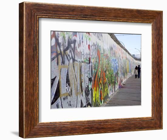 Couple Walking Along the East Side Gallery Berlin Wall Mural, Berlin, Germany, Europe-Simon Montgomery-Framed Photographic Print