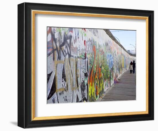 Couple Walking Along the East Side Gallery Berlin Wall Mural, Berlin, Germany, Europe-Simon Montgomery-Framed Photographic Print