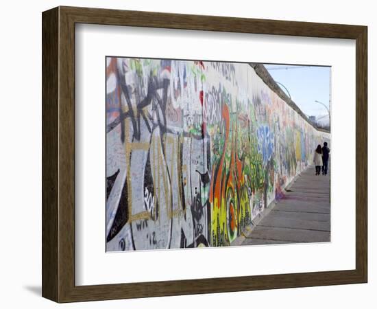 Couple Walking Along the East Side Gallery Berlin Wall Mural, Berlin, Germany, Europe-Simon Montgomery-Framed Premium Photographic Print