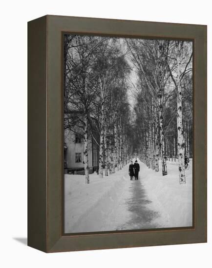 Couple Walking Through a Snow Covered Road-Carl Mydans-Framed Premier Image Canvas