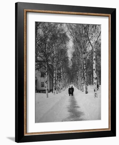 Couple Walking Through a Snow Covered Road-Carl Mydans-Framed Photographic Print