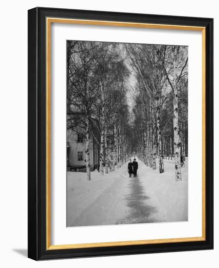 Couple Walking Through a Snow Covered Road-Carl Mydans-Framed Photographic Print