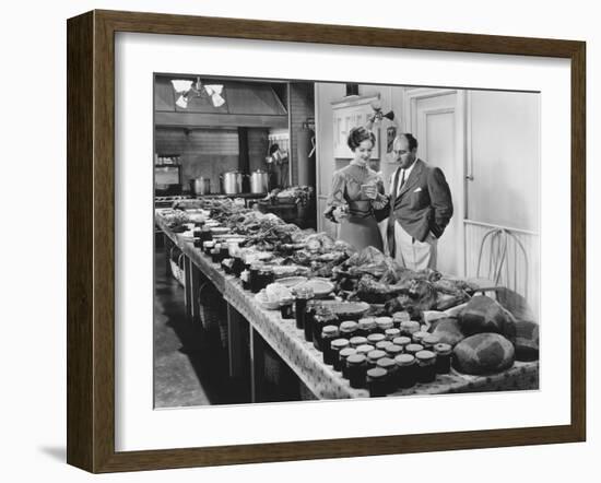 Couple with Table Covered in Food for Holiday Meal-null-Framed Photo