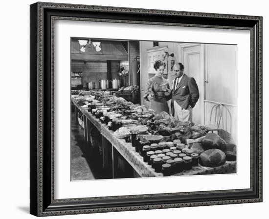 Couple with Table Covered in Food for Holiday Meal-null-Framed Photo