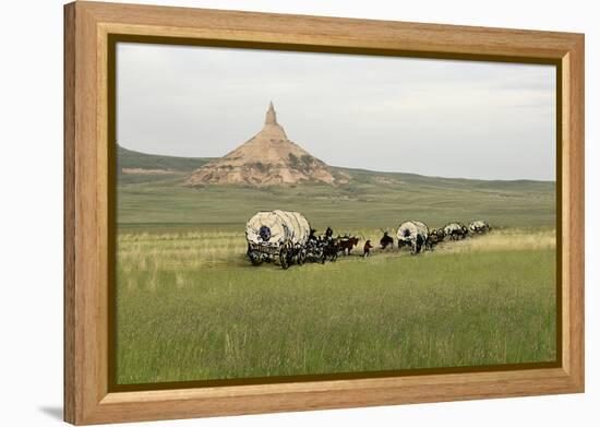 Covered Wagons Passing Chimney Rock, a Landmark on the Oregon Trail, Nebraska-null-Framed Premier Image Canvas