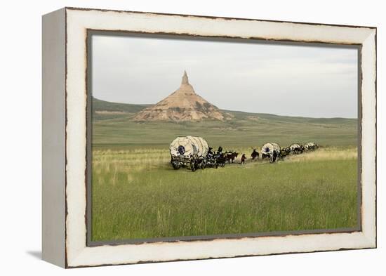 Covered Wagons Passing Chimney Rock, a Landmark on the Oregon Trail, Nebraska-null-Framed Premier Image Canvas