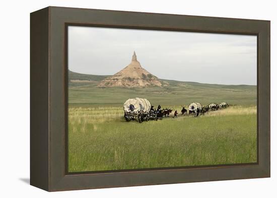 Covered Wagons Passing Chimney Rock, a Landmark on the Oregon Trail, Nebraska-null-Framed Premier Image Canvas