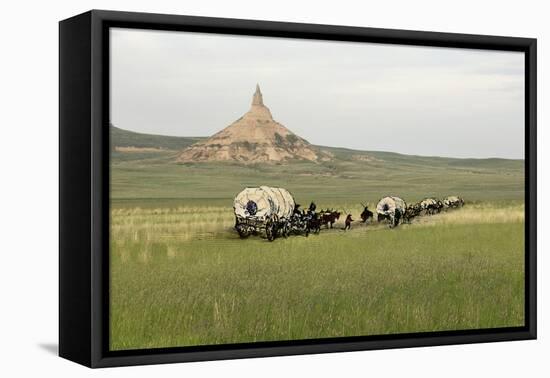 Covered Wagons Passing Chimney Rock, a Landmark on the Oregon Trail, Nebraska-null-Framed Premier Image Canvas