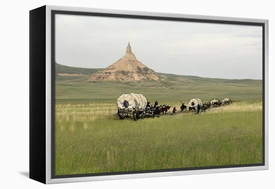 Covered Wagons Passing Chimney Rock, a Landmark on the Oregon Trail, Nebraska-null-Framed Premier Image Canvas