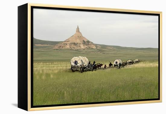 Covered Wagons Passing Chimney Rock, a Landmark on the Oregon Trail, Nebraska-null-Framed Premier Image Canvas