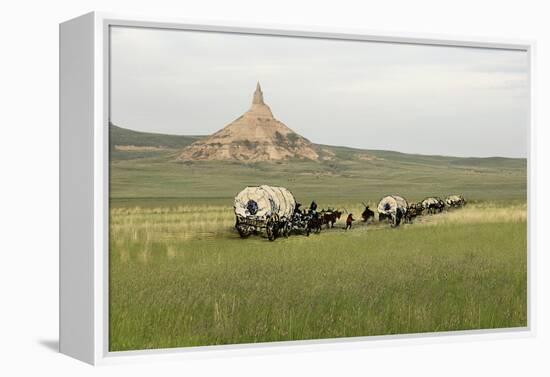 Covered Wagons Passing Chimney Rock, a Landmark on the Oregon Trail, Nebraska-null-Framed Premier Image Canvas