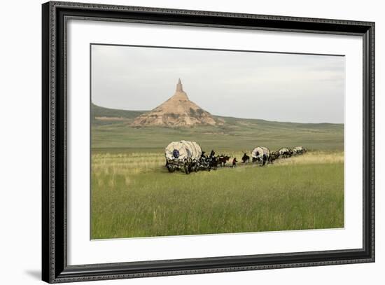 Covered Wagons Passing Chimney Rock, a Landmark on the Oregon Trail, Nebraska-null-Framed Photographic Print