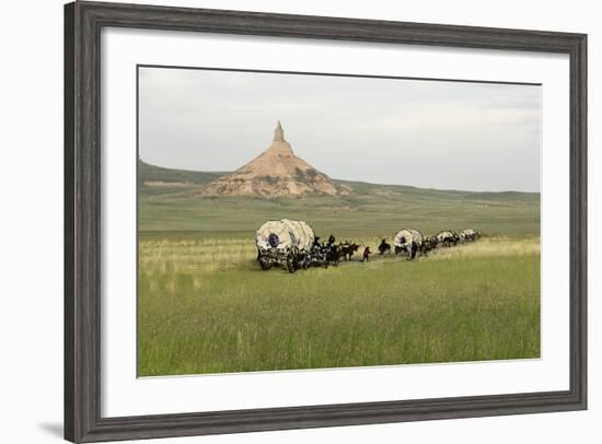 Covered Wagons Passing Chimney Rock, a Landmark on the Oregon Trail, Nebraska-null-Framed Photographic Print