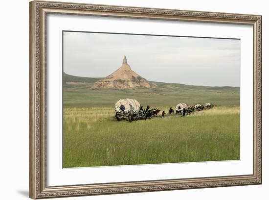 Covered Wagons Passing Chimney Rock, a Landmark on the Oregon Trail, Nebraska-null-Framed Photographic Print