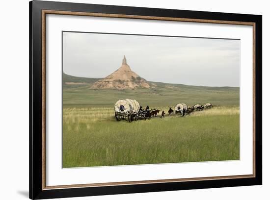 Covered Wagons Passing Chimney Rock, a Landmark on the Oregon Trail, Nebraska-null-Framed Photographic Print