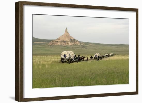 Covered Wagons Passing Chimney Rock, a Landmark on the Oregon Trail, Nebraska-null-Framed Photographic Print