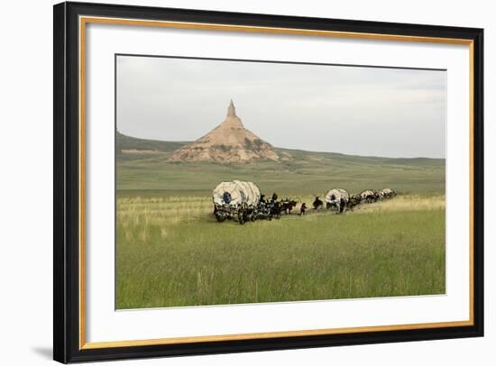 Covered Wagons Passing Chimney Rock, a Landmark on the Oregon Trail, Nebraska-null-Framed Photographic Print