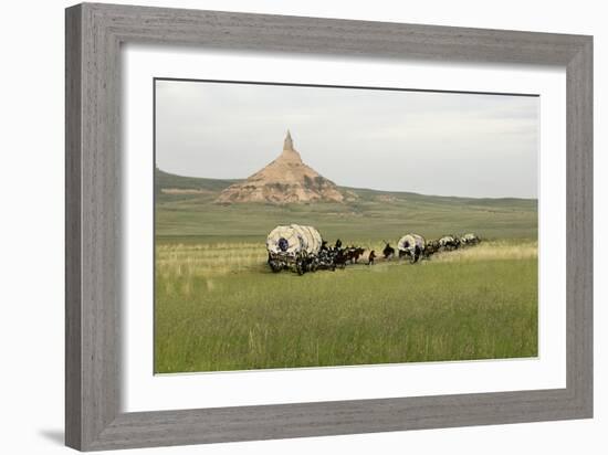 Covered Wagons Passing Chimney Rock, a Landmark on the Oregon Trail, Nebraska-null-Framed Photographic Print