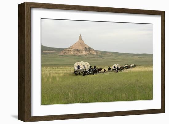 Covered Wagons Passing Chimney Rock, a Landmark on the Oregon Trail, Nebraska-null-Framed Photographic Print