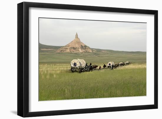 Covered Wagons Passing Chimney Rock, a Landmark on the Oregon Trail, Nebraska-null-Framed Photographic Print