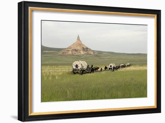 Covered Wagons Passing Chimney Rock, a Landmark on the Oregon Trail, Nebraska-null-Framed Photographic Print