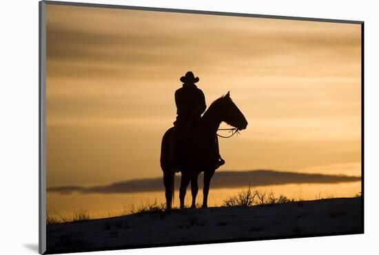 Cowboy at Sunset-Darrell Gulin-Mounted Photographic Print