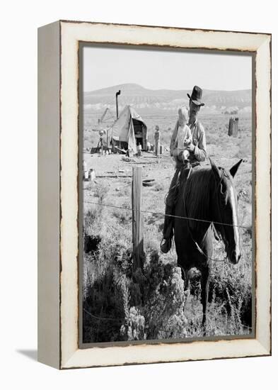 Cowboy Holds His Baby While Riding a Horse-Dorothea Lange-Framed Stretched Canvas