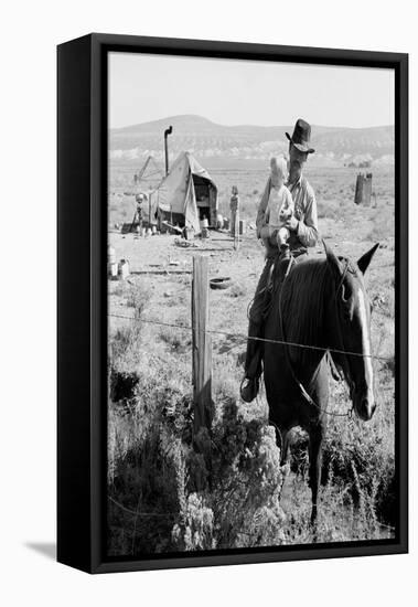 Cowboy Holds His Baby While Riding a Horse-Dorothea Lange-Framed Stretched Canvas