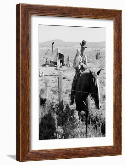 Cowboy Holds His Baby While Riding a Horse-Dorothea Lange-Framed Art Print