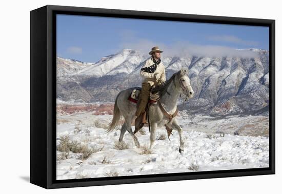 Cowboy On Grey Quarter Horse Trotting In The Snow At Flitner Ranch, Shell, Wyoming-Carol Walker-Framed Premier Image Canvas