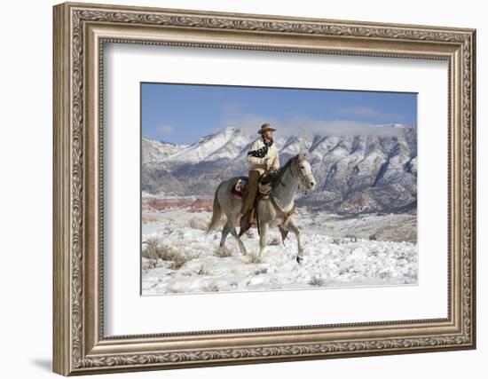 Cowboy On Grey Quarter Horse Trotting In The Snow At Flitner Ranch, Shell, Wyoming-Carol Walker-Framed Photographic Print