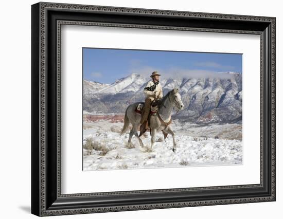 Cowboy On Grey Quarter Horse Trotting In The Snow At Flitner Ranch, Shell, Wyoming-Carol Walker-Framed Photographic Print