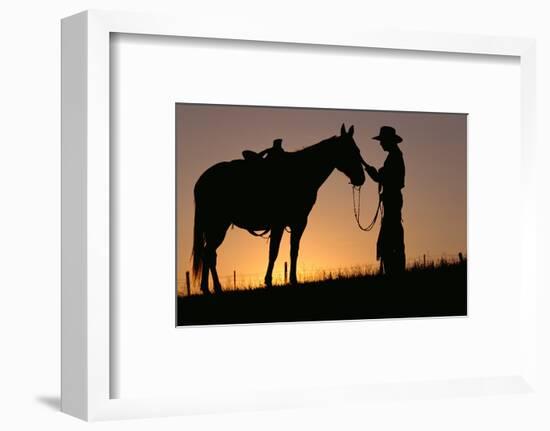 Cowboy Petting Horse at Sunset-Darrell Gulin-Framed Photographic Print