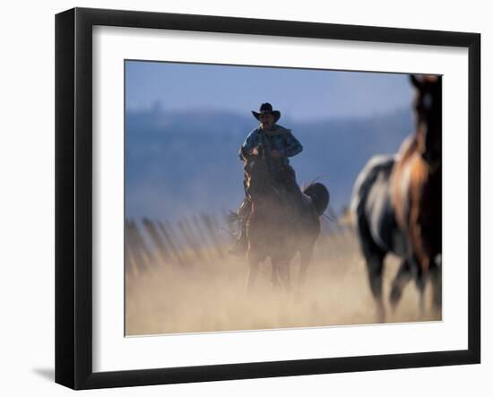 Cowboy Riding Horseback, Oregon, USA-William Sutton-Framed Photographic Print