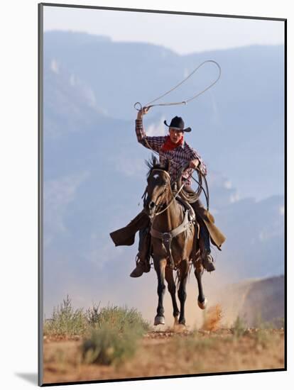 Cowboy Running with Rope Lassoo in Hand, Flitner Ranch, Shell, Wyoming, USA-Carol Walker-Mounted Photographic Print