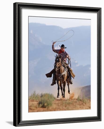 Cowboy Running with Rope Lassoo in Hand, Flitner Ranch, Shell, Wyoming, USA-Carol Walker-Framed Photographic Print