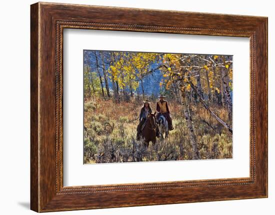 Cowgirl and Cowboy Riding Together-Terry Eggers-Framed Photographic Print